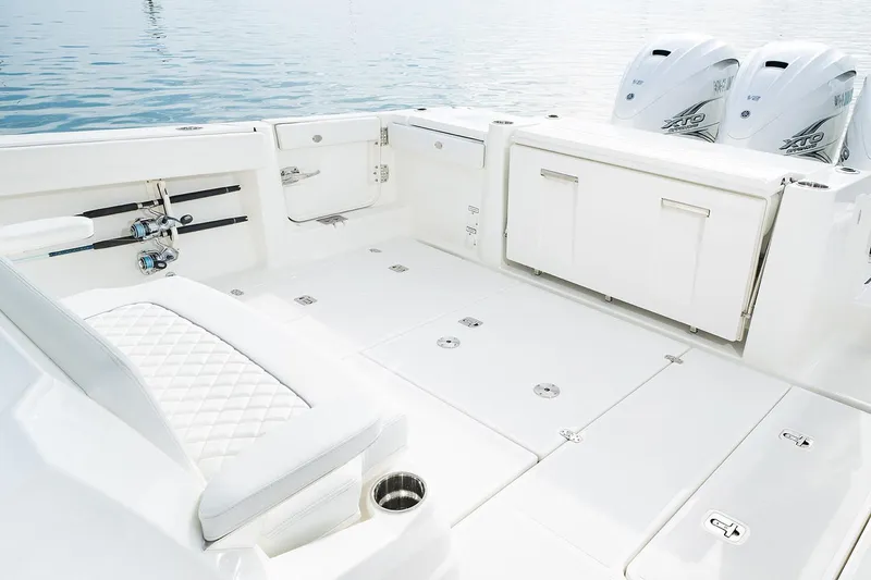 Slide: The Image of 2021 Pursuit S 378 Sport boat with triple engines, cruising near luxury waterfront residences. - 12