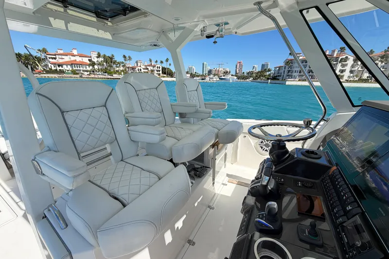 Slide: The Image of Interior of 2021 Pursuit S 378 Sport boat with luxurious seating and modern controls. - 22