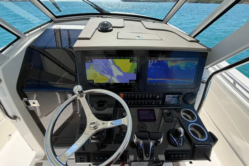 Slide: The Image of 2021 Pursuit S 378 Sport boat dashboard with navigation screens and steering wheel. - 24