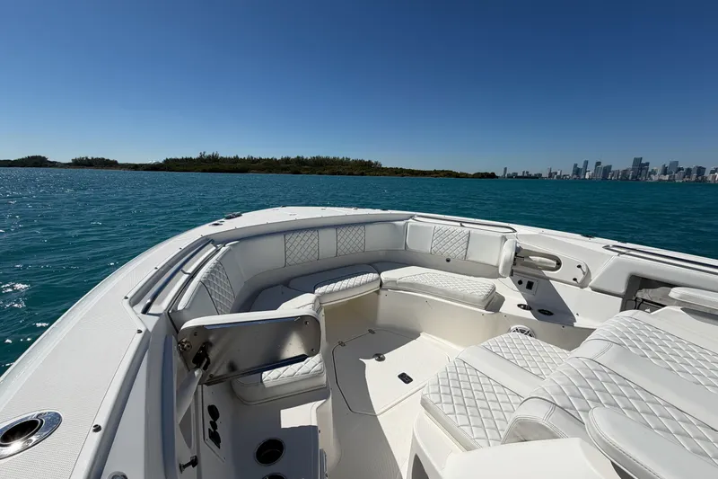 Slide: The Image of 2021 Pursuit S 378 Sport boat with luxurious seating, cruising on clear blue waters. - 28