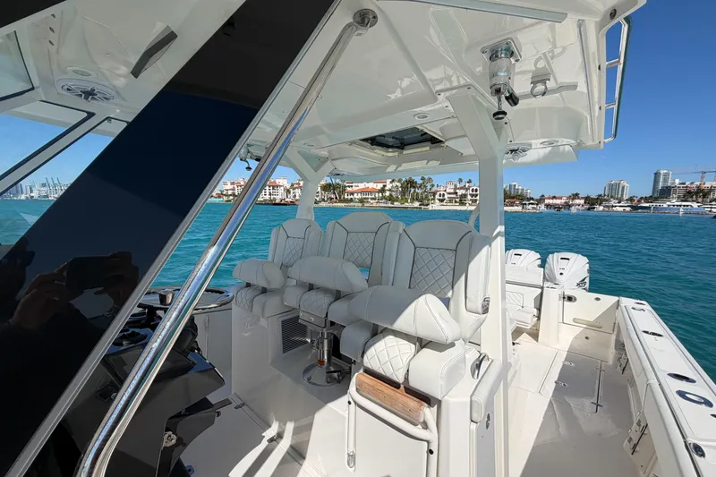 Slide: The Image of 2021 Pursuit S 378 Sport boat interior with luxurious seating on a sunny day. - 32