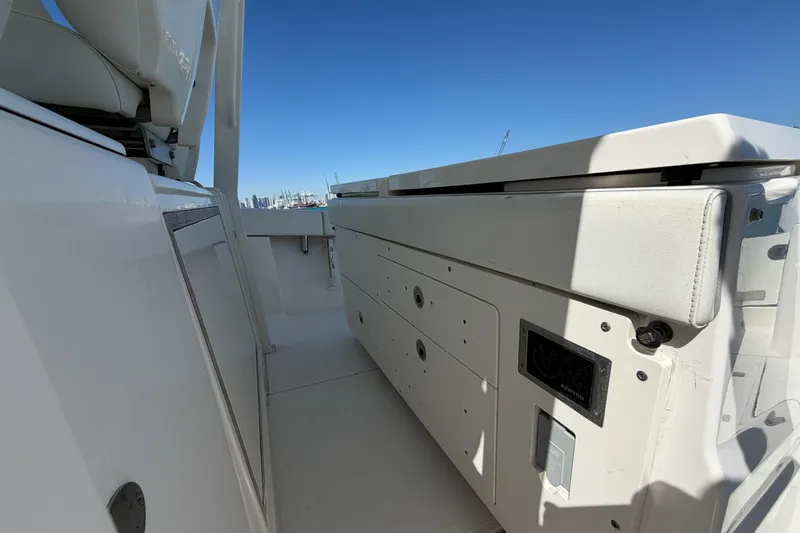 Slide: The Image of 2021 Pursuit S 378 Sport boat interior with storage compartments and seating. - 33