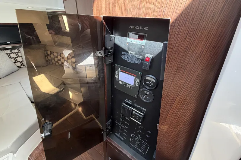 Slide: The Image of Electrical panel inside 2021 Pursuit S 378 Sport boat, featuring 240 volts AC controls. - 36