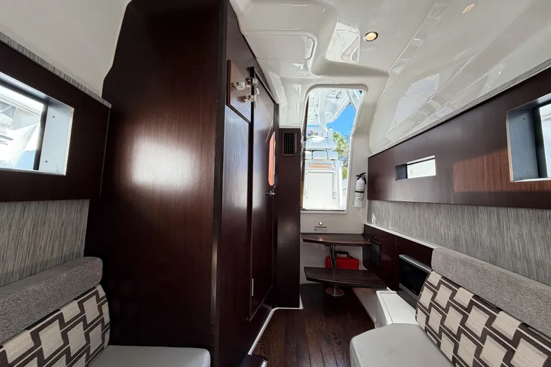 Slide: The Image of Interior of 2021 Pursuit S 378 Sport boat with modern seating and wood accents. - 40