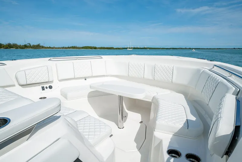 Slide: The Image of 2021 Pursuit S 378 Sport boat on turquoise water with city skyline background. - 8