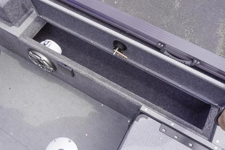 Slide: The Image of 2025 G3 Angler V178 F boat interior storage compartment with speaker and carpeted finish. - 24