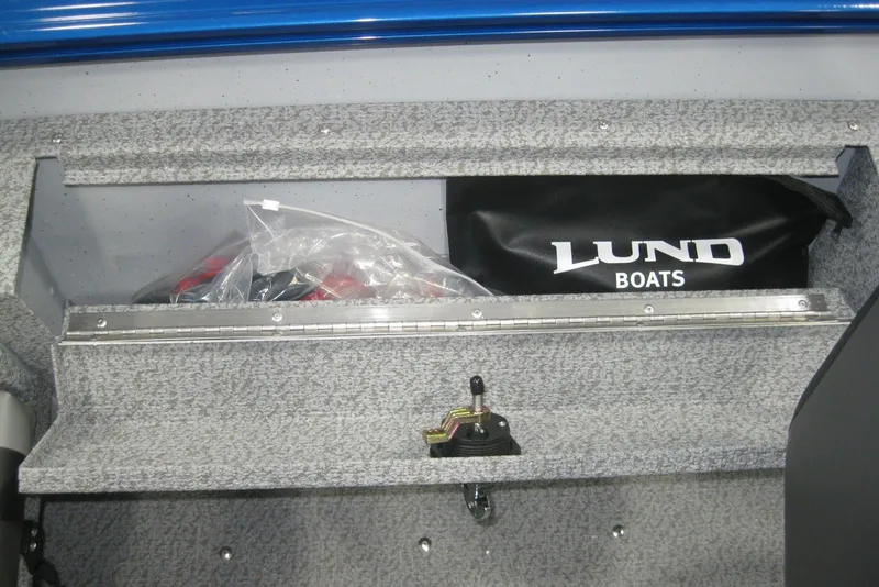 Slide: The Image of 2025 Lund 1675 Adventure SS boat interior with gray carpet and steering wheel. - 10