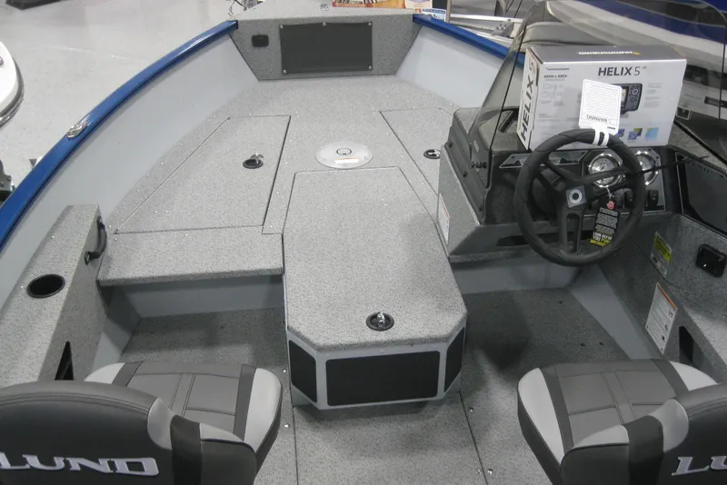 Slide: The Image of 2025 Lund 1675 Adventure SS boat interior with steering console and two seats. - 6