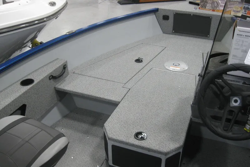 Slide: The Image of 2025 Lund 1675 Adventure SS boat interior with seating and storage compartments. - 9