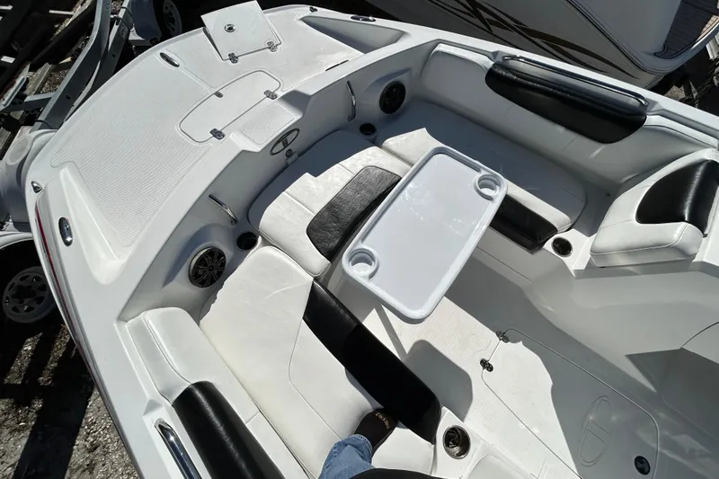 Slide: The Image of 2017 Tahoe 2150 boat interior with seating and table setup. - 10