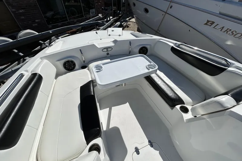 Slide: The Image of 2017 Tahoe 2150 boat interior with seating and table, featuring black and white upholstery. - 8