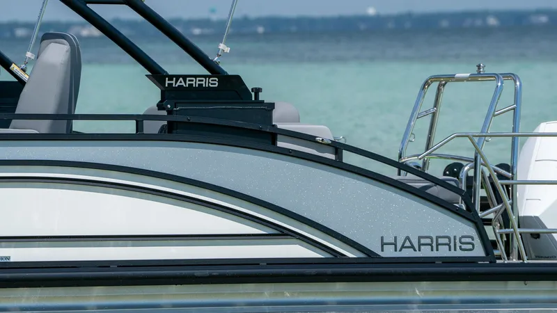 Slide: The Image of Harris Solstice 230 boat, 2026 model, on calm water. - 7