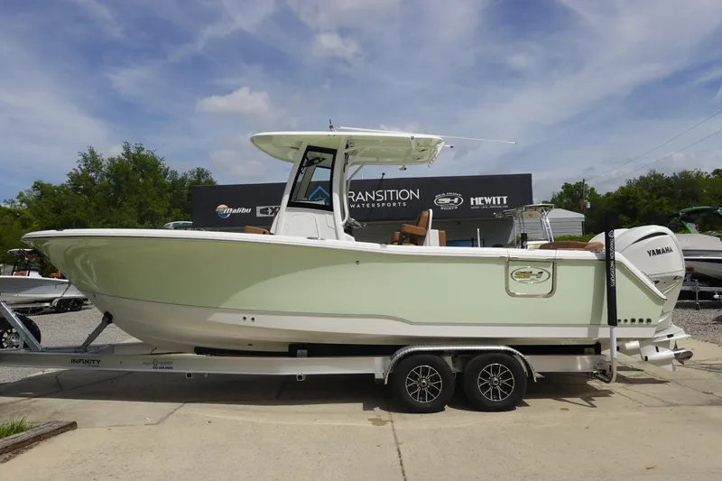 The Image of 2026 Sea Hunt Ultra 275 Coffin Box boat on trailer, outdoors, with Yamaha engine. - 0