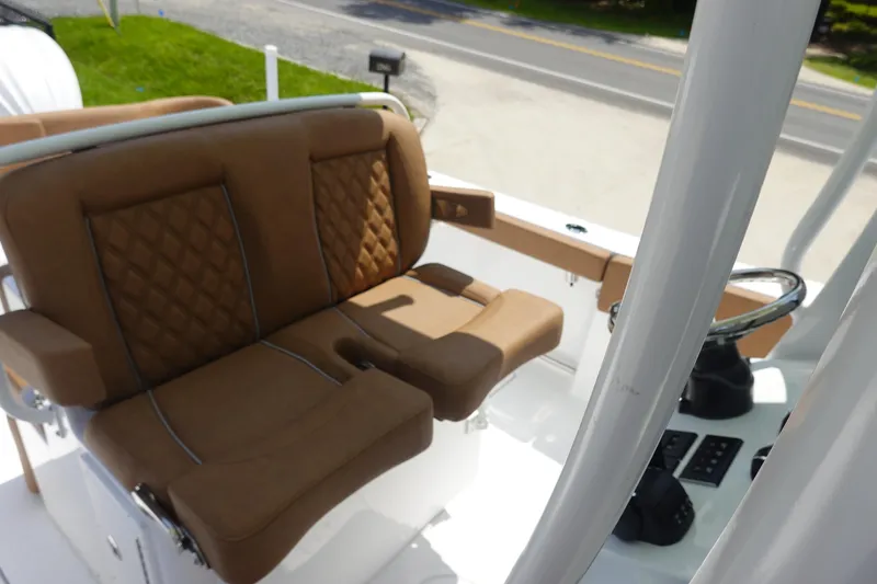 Slide: The Image of 2026 Sea Hunt Ultra 275 Coffin Box with brown cushioned seating and white interior. - 17