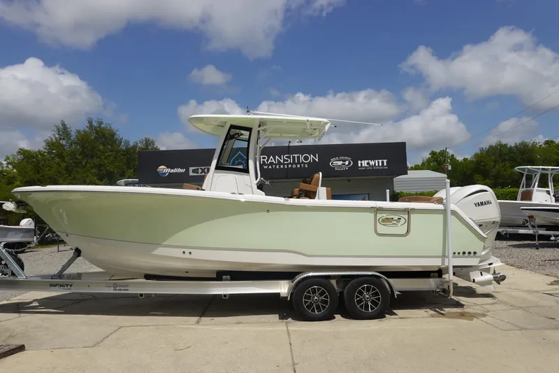 Slide: The Image of 2026 Sea Hunt Ultra 275 Coffin Box boat on trailer, parked outdoors. - 2