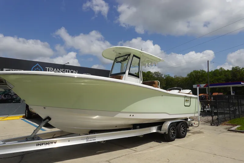 Slide: The Image of 2026 Sea Hunt Ultra 275 Coffin Box boat on trailer, parked outdoors. - 3