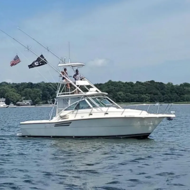 The Image of 1997 Pursuit 3000 Express boat on calm water. - 0