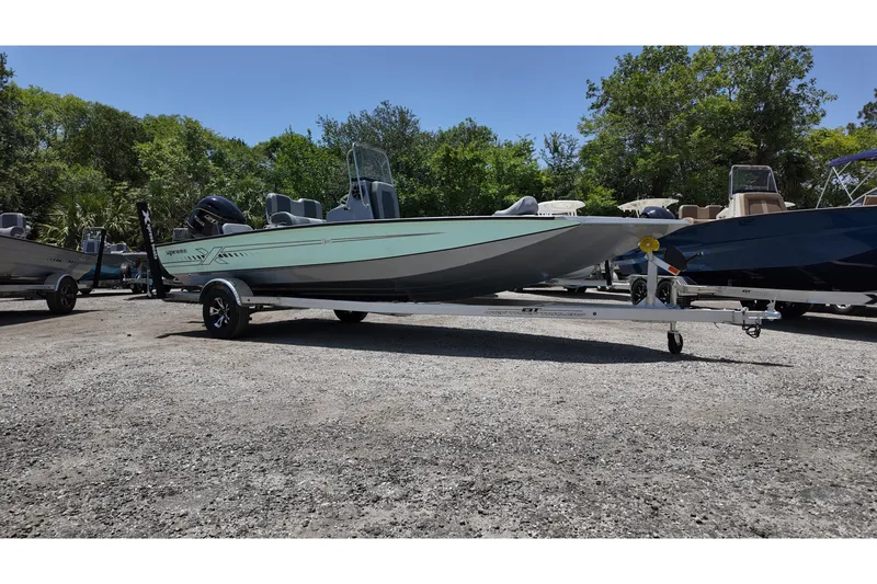 The Image of 2026 Xpress H20B Bay boat on trailer, parked outdoors with trees in background. - 0