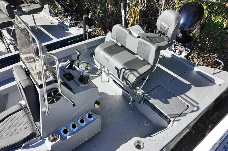 Slide: The Image of 2026 Xpress H20B Bay boat interior with seating and steering console. - 11