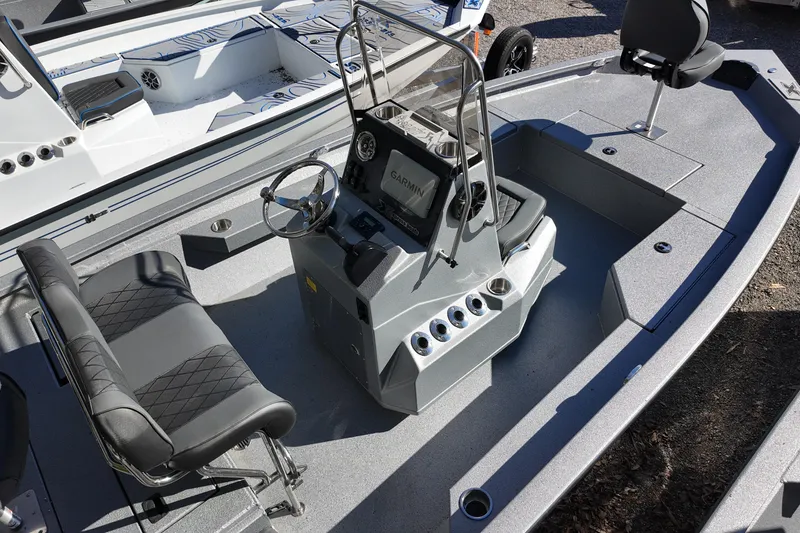 Slide: The Image of 2026 Xpress H20B Bay boat interior with steering console and seating. - 4