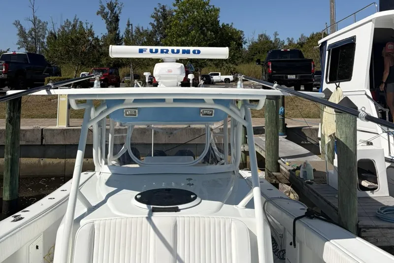 Slide: The Image of 2009 Yellowfin 42 Offshore boat docked, featuring Furuno radar and spacious deck. - 10