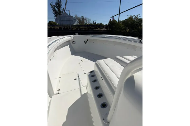 Slide: The Image of 2009 Yellowfin 42 Offshore boat interior with white seating and deck. - 12