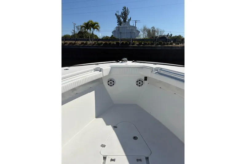 Slide: The Image of 2009 Yellowfin 42 Offshore boat interior with white seating and speakers. - 14