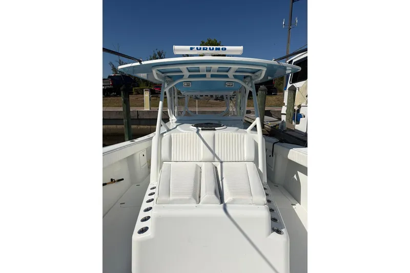 Slide: The Image of 2009 Yellowfin 42 Offshore boat with white seating and Furuno radar, docked under clear skies. - 15