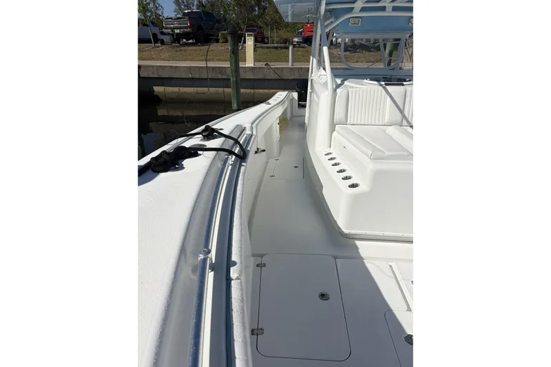 Slide: The Image of 2009 Yellowfin 42 Offshore boat deck with seating and storage compartments. - 16