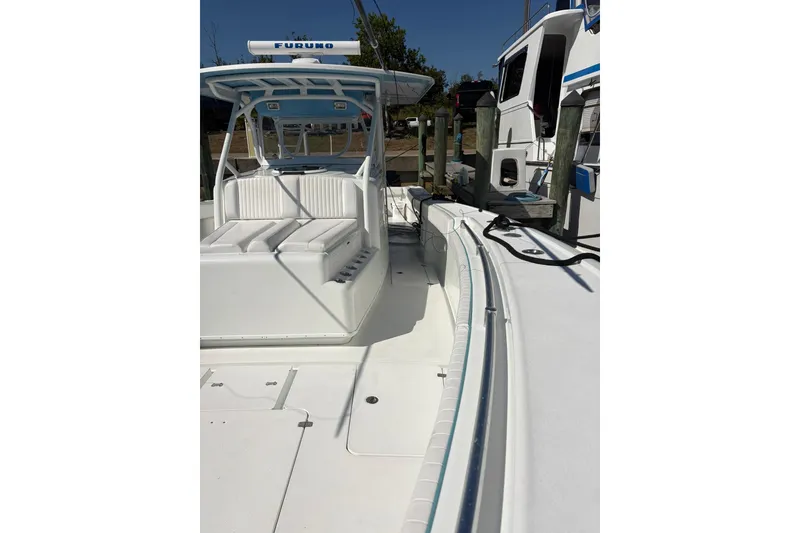 Slide: The Image of 2009 Yellowfin 42 Offshore boat with spacious deck and seating, docked at marina. - 17
