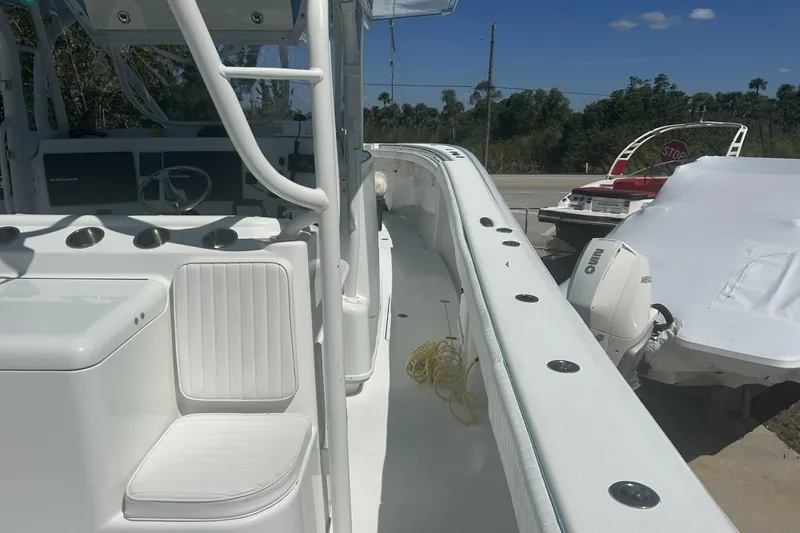 Slide: The Image of 2009 Yellowfin 42 Offshore boat interior with seating and controls, docked outdoors. - 6