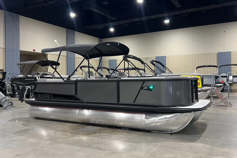The Image of 2026 Alera A22Q pontoon boat displayed indoors with sleek design and canopy. - 0