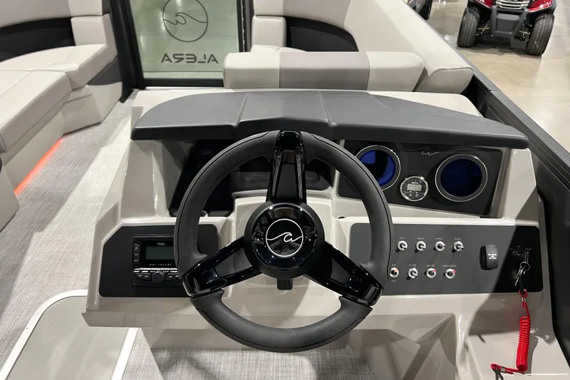 Slide: The Image of Interior view of 2026 Alera A22Q boat dashboard with steering wheel and controls. - 11
