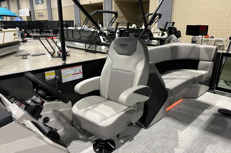 Slide: The Image of Interior of 2026 Alera A22Q boat with modern seating and steering console. - 13