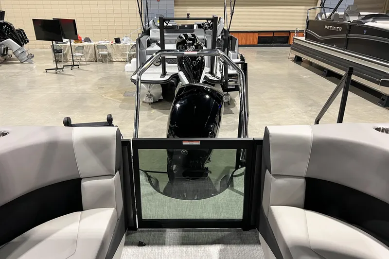 Slide: The Image of 2026 Alera A22Q boat interior with modern seating and engine view at a showroom. - 16