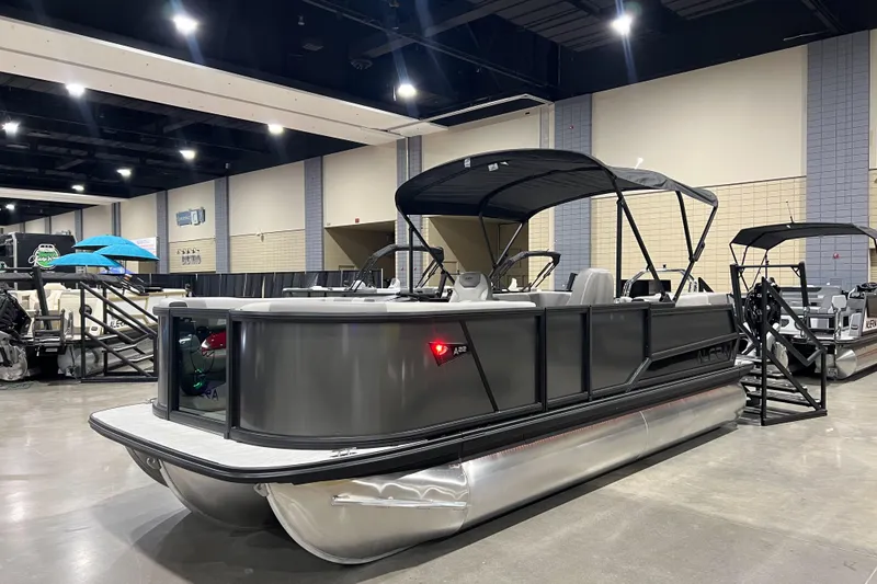 Slide: The Image of 2026 Alera A22Q pontoon boat displayed indoors at a boat show. - 3
