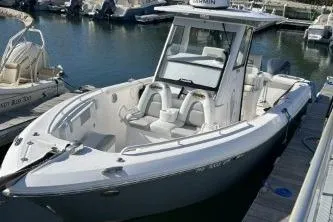 The Image of 2013 Everglades 275 Center Console boat docked in a marina. - 0