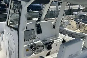 Slide: The Image of 2013 Everglades 275 Center Console boat interior with steering wheel and control panel. - 3