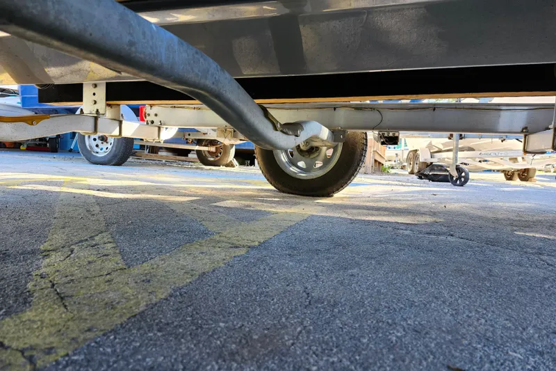 Slide: The Image of Underneath view of a 2022 Bulls Bay 2000 boat trailer on pavement. - 11
