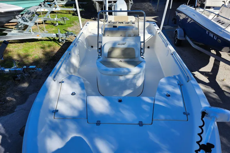 Slide: The Image of 2022 Bulls Bay 2000 boat, white interior, parked on trailer, outdoor setting. - 13