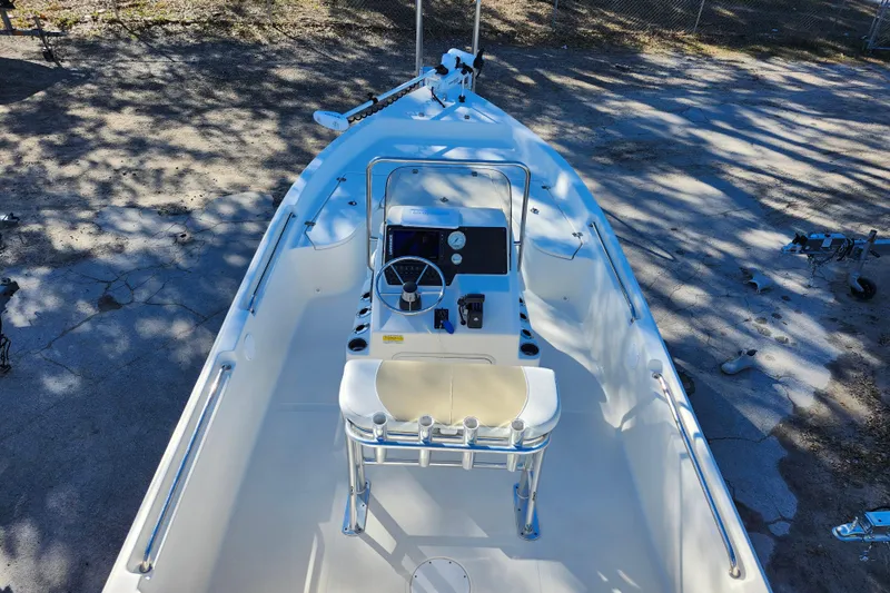 Slide: The Image of 2022 Bulls Bay 2000 boat interior with steering console and seating, parked on concrete. - 21