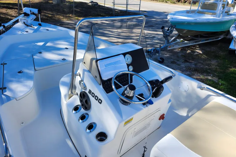 Slide: The Image of Bulls Bay 2000 boat interior, 2022 model, featuring steering console and seating. - 25