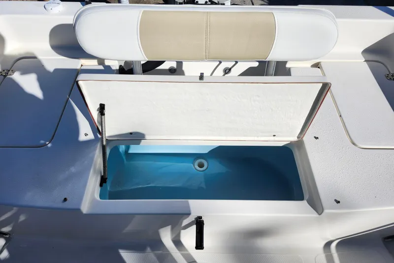 Slide: The Image of 2022 Bulls Bay 2000 boat with open storage compartment and cushioned seat. - 28