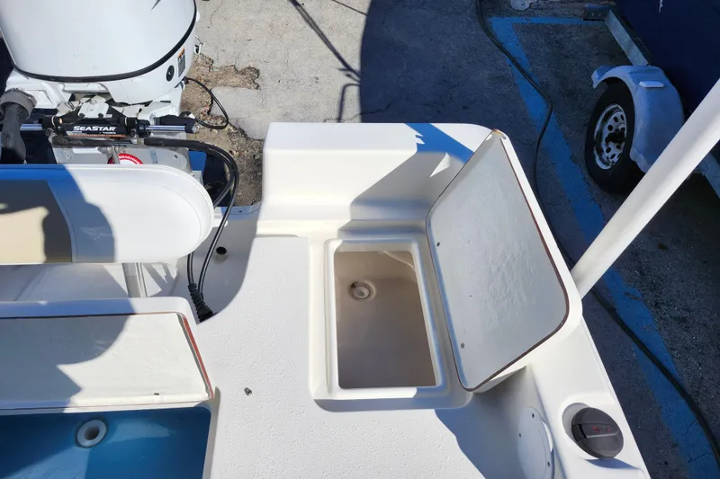 Slide: The Image of 2022 Bulls Bay 2000 boat with open storage compartment and visible engine. - 29