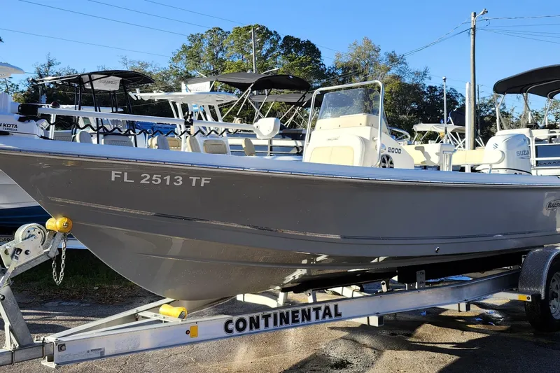 Slide: The Image of 2022 Bulls Bay 2000 boat on trailer, displayed outdoors with other boats. - 3