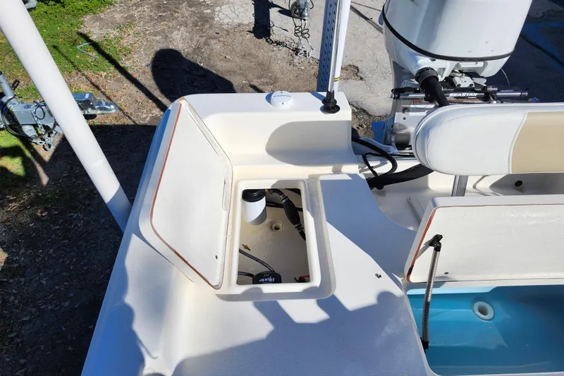 Slide: The Image of 2022 Bulls Bay 2000 boat interior with open storage compartment and engine view. - 30