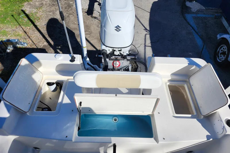 Slide: The Image of Bulls Bay 2000 boat, 2022 model, featuring open storage compartments and a Suzuki outboard motor. - 31