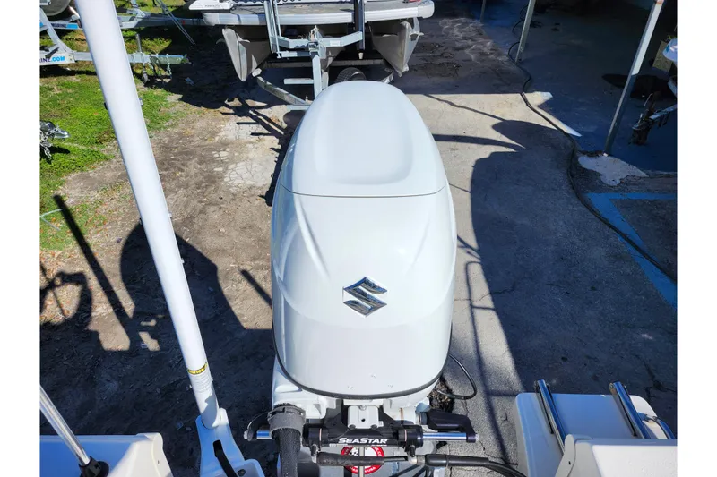 Slide: The Image of Bulls Bay 2000 boat with Suzuki outboard motor, 2022 model, parked on concrete. - 33