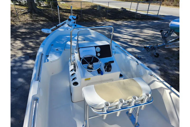 Slide: The Image of 2022 Bulls Bay 2000 boat interior with steering console and seating, parked outdoors. - 34