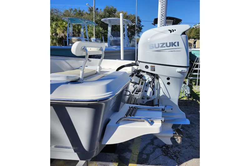 Slide: The Image of 2022 Bulls Bay 2000 boat with Suzuki outboard motor, docked outdoors. - 6